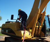 Image of a man refueling a heavy equipment machine