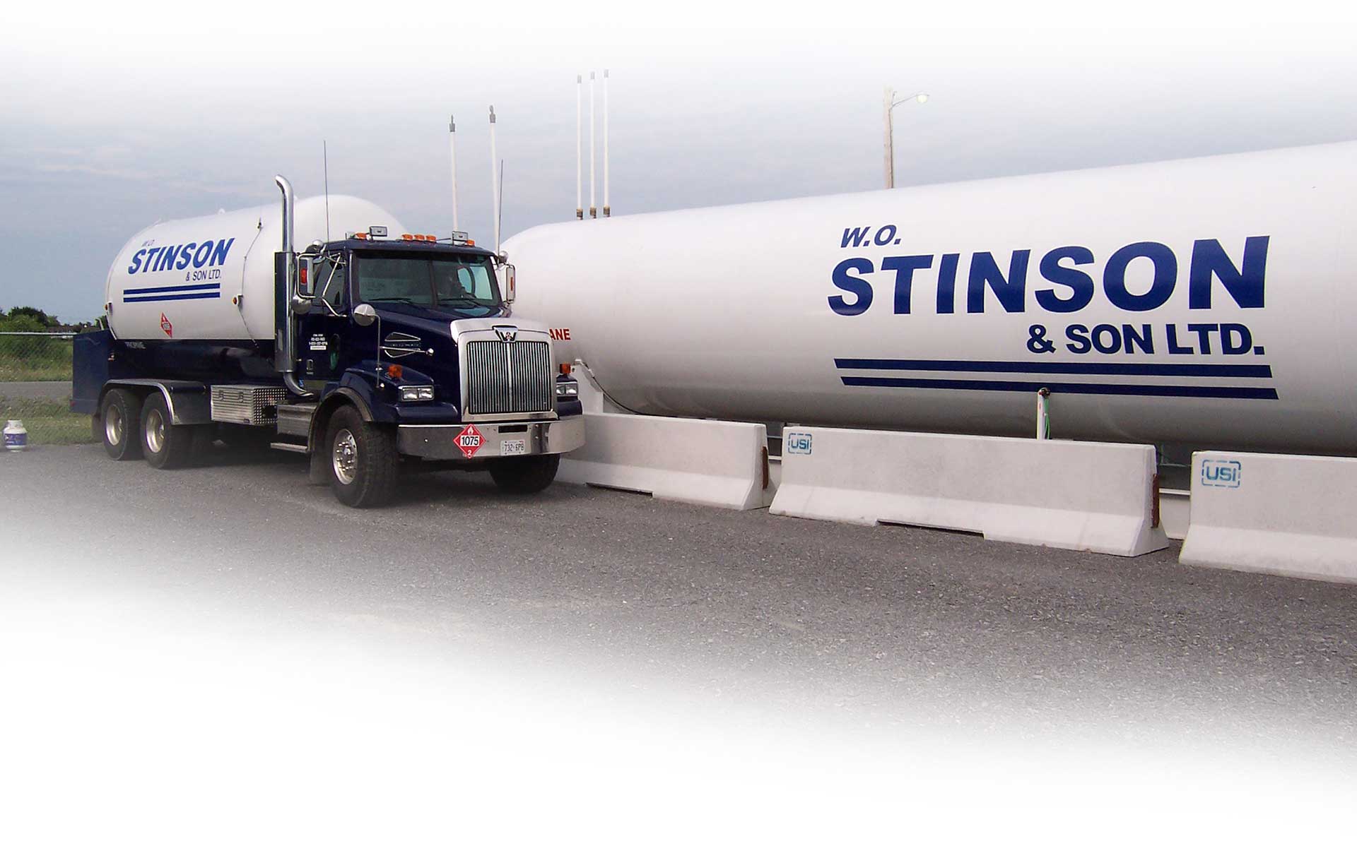 home-center-lager Image of a Stinson delivery truck beside a large cylinder propane tank